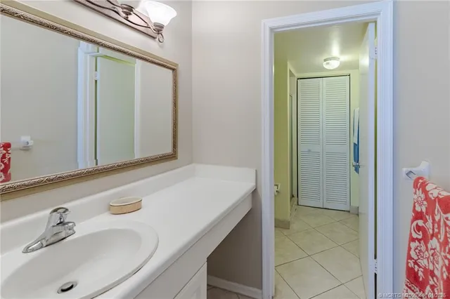 a dining room with wooden floor a chandelier a wooden table and chairs