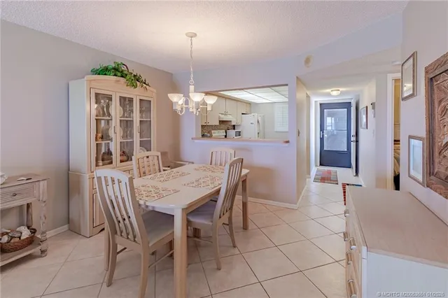 a view of a dining room with furniture and a chandelier