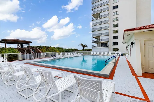 a view of swimming pool with a lounge chairs