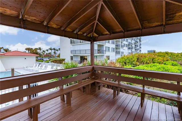 a wooden bench sitting in front of a building