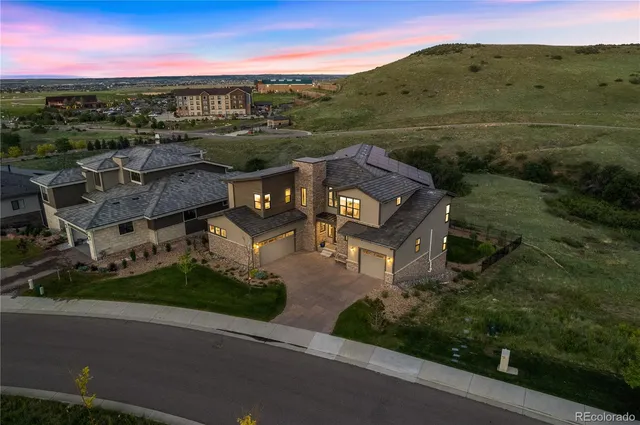 an aerial view of residential houses with outdoor space and street view
