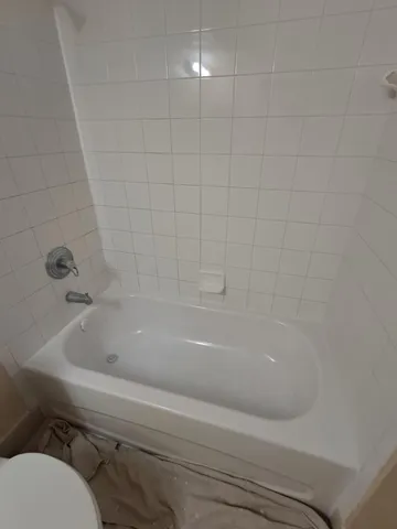 a bathroom with a bathtub and toilet