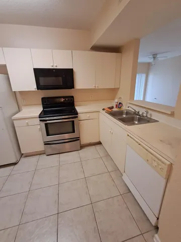 a kitchen with a stove a sink and a refrigerator