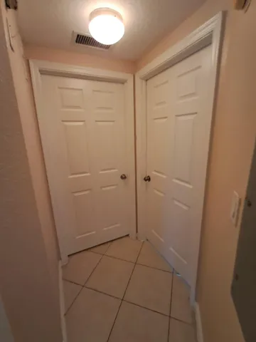 an empty room with a ceiling fan and a window