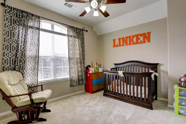a bedroom with furniture and a window