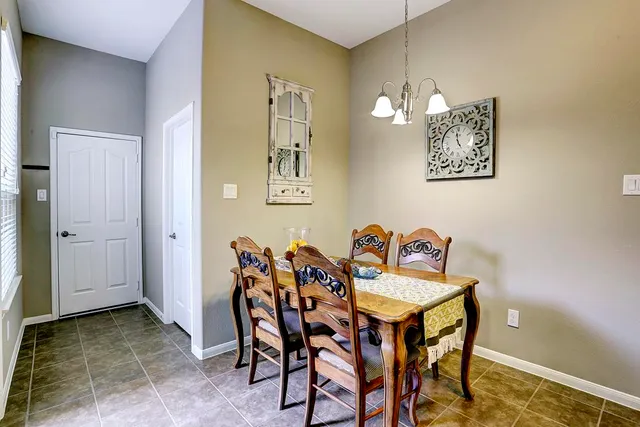 a view of a dining room with furniture and chandelier