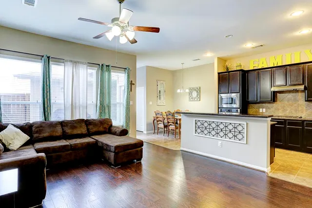 a living room with furniture and a large window