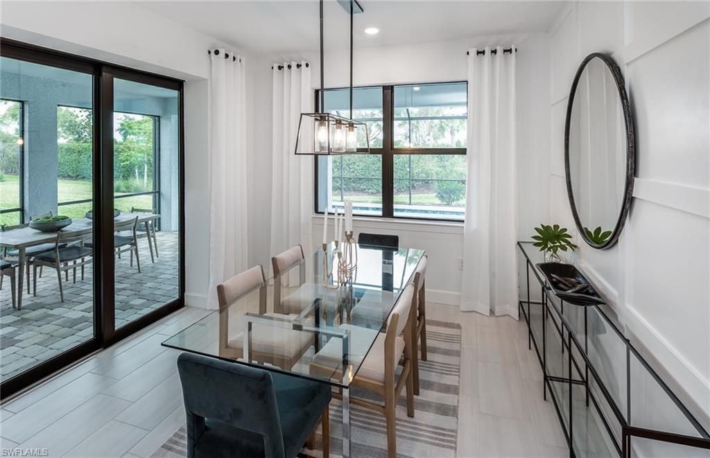 5637 Celebration Drive Immokalee, FL 34142 - Photo 10 of 35 a view of a dining room with furniture a chandelier and wooden floor