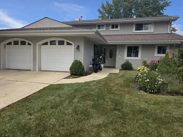 a front view of a house with a porch and outdoor seating