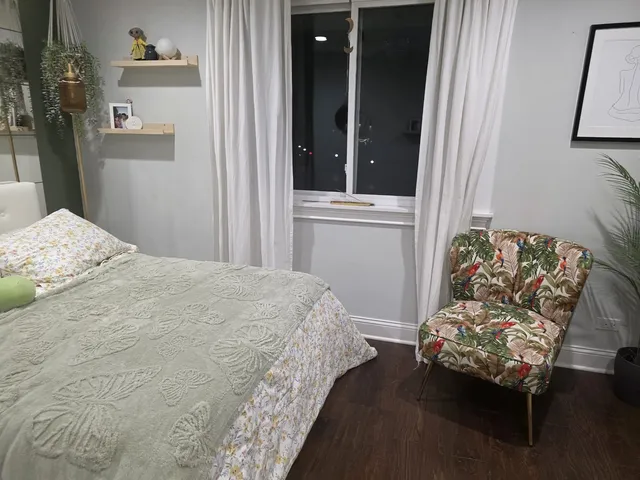 a bedroom with furniture and a wooden floor