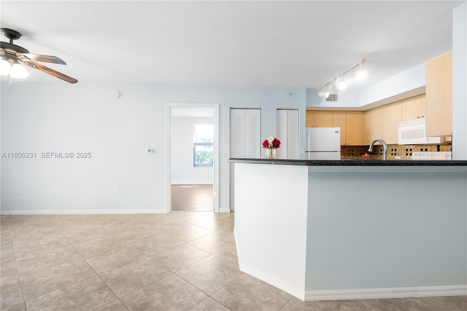 1308 Villa Circle, Unit 1308 Boynton Beach, FL 33435 - Photo 3 of 35 a view of a kitchen with a sink and a microwave