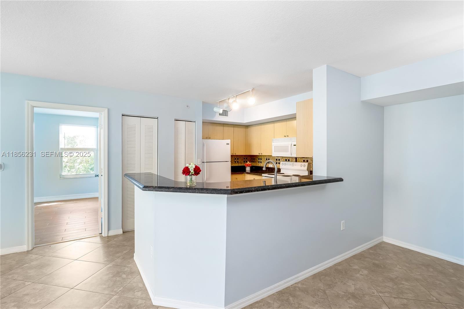 1308 Villa Circle, Unit 1308 Boynton Beach, FL 33435 - Photo 4 of 35 a kitchen with stainless steel appliances a sink and a refrigerator