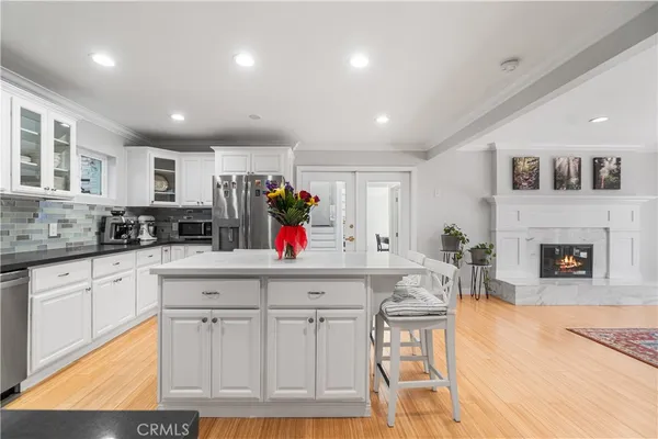 a kitchen with furniture and a fireplace