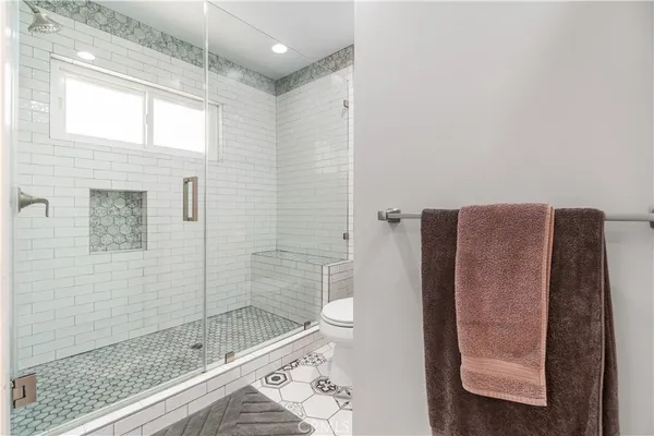 a bathroom with a toilet and a shower