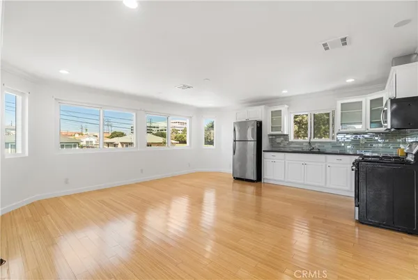 a kitchen with stainless steel appliances granite countertop a stove and a microwave