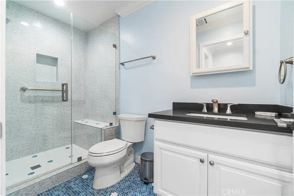 a bathroom with a toilet and a shower