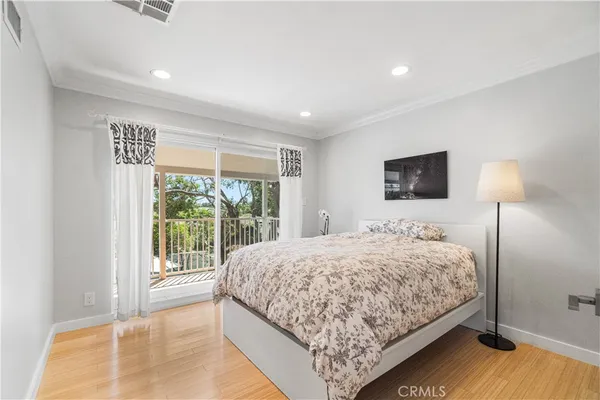 a bedroom with a large bed and a large window
