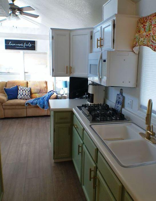 84136 Ave 44, Unit 602 Indio, CA 92203 - Photo 20 of 43 a kitchen with a stove and a wooden floor