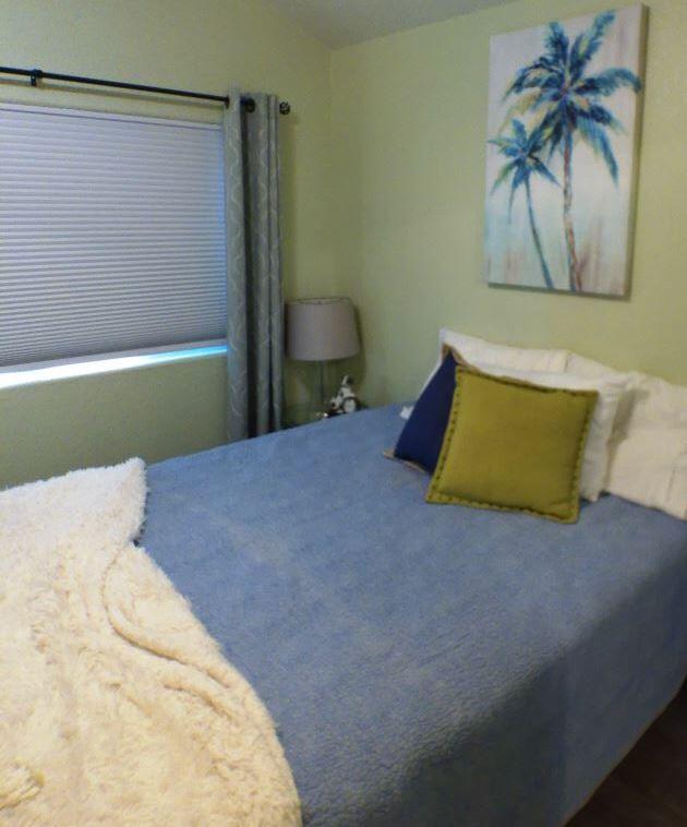 84136 Ave 44, Unit 602 Indio, CA 92203 - Photo 28 of 43 a bedroom with a bed and a painting on the wall