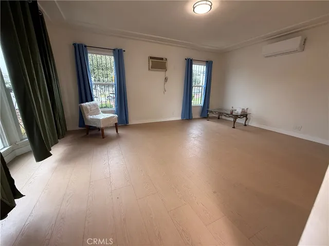 an empty room with windows and closet