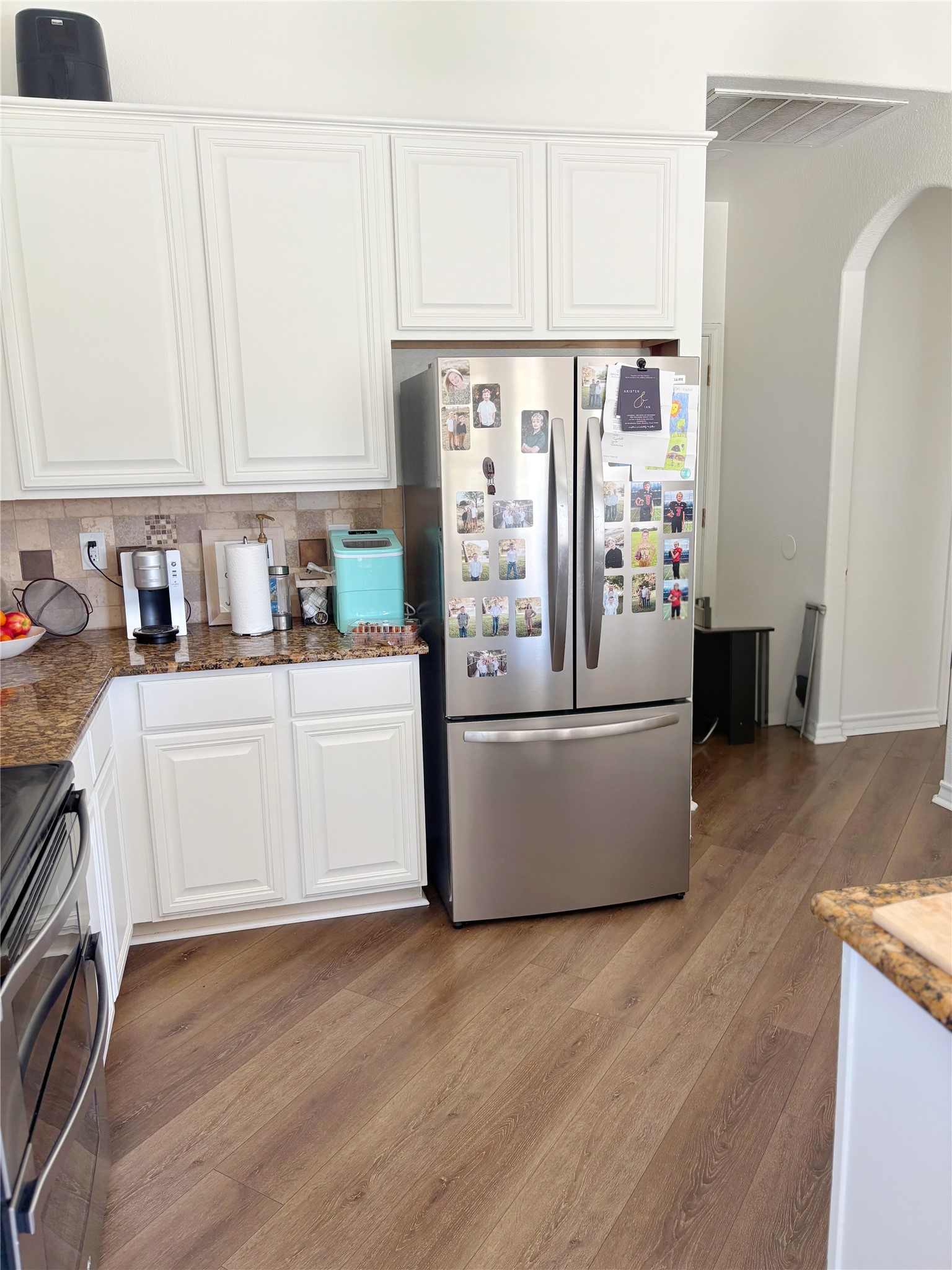 3336 Ashleys Way Marion, TX 78124 - Photo 5 of 15 Kitchen with white cabinetry, stainless steel appliances, light wood-style floors, and dark stone counters