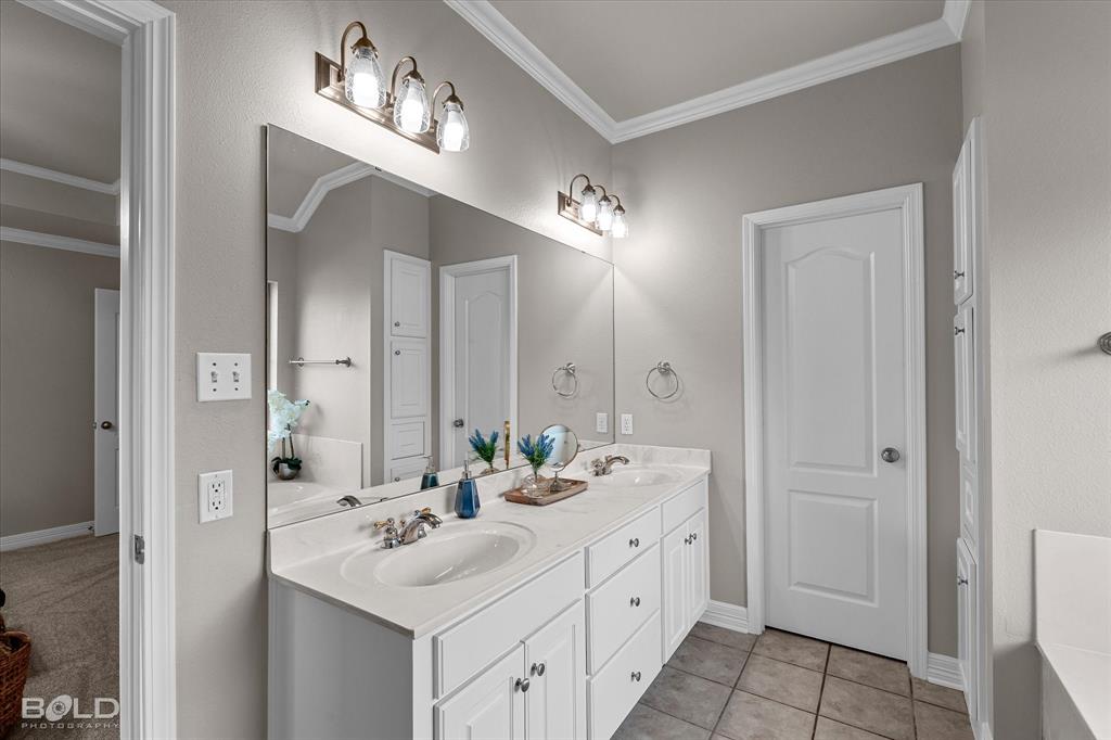 116 Augusta Avenue Benton, LA 71006 - Photo 23 of 38 a bathroom with double sink and a mirror