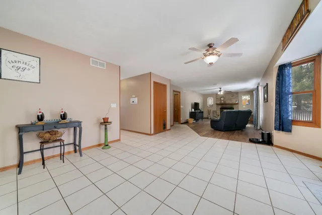 a living room with furniture a dining table and a large window