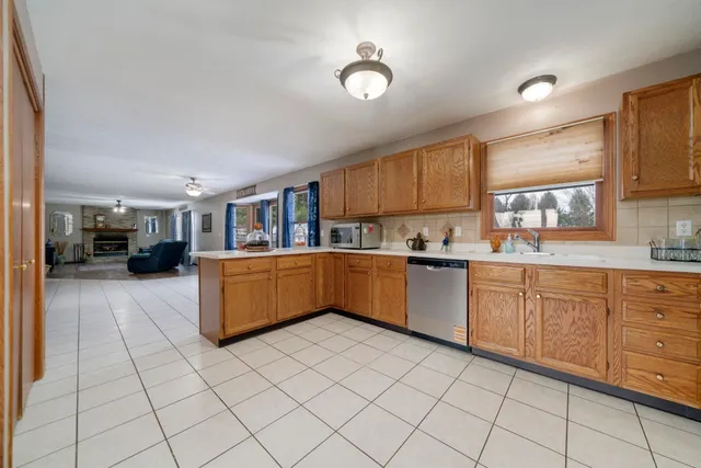 a kitchen with stainless steel appliances granite countertop a sink and cabinets