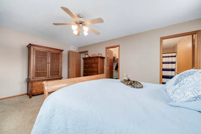 a view of a livingroom with a window and a ceiling fan