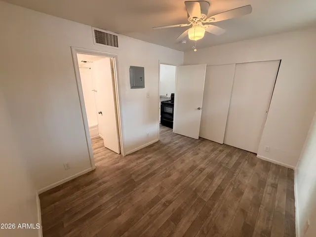 a view of empty room with wooden floor