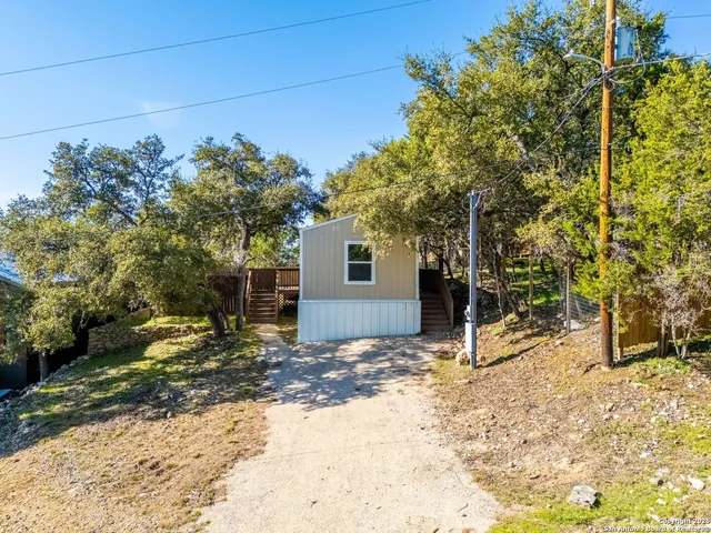 a view of a house with a tree in the background