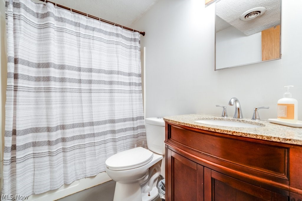 151 Meadowridge Road Mogadore, OH 44260 - Photo 18 of 26 Bathroom featuring vanity and a textured ceiling