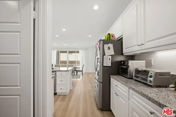 a kitchen with a refrigerator and a sink