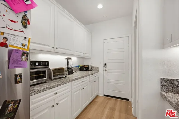 a kitchen with granite countertop a sink and cabinets