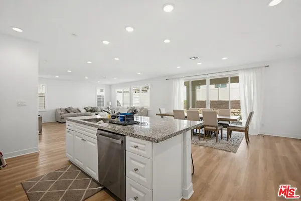 a kitchen with stainless steel appliances granite countertop a stove and a sink