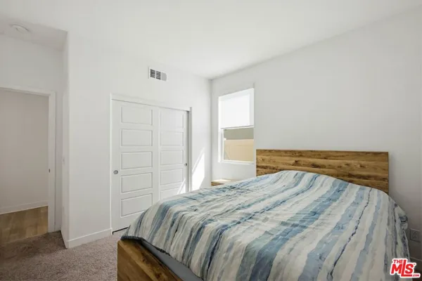 a bedroom with a bed and pillows