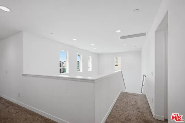 a view of hallway with kitchen