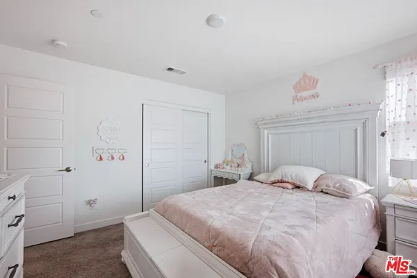 a bedroom with bed and a window