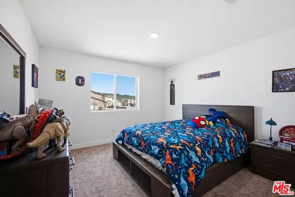 a bedroom with a bed and cabinets