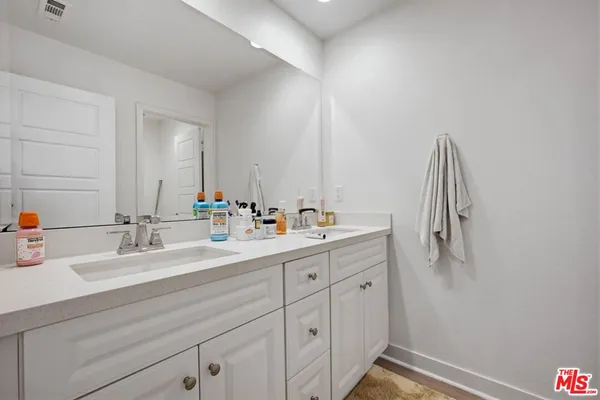 a white toilet sitting next to a bathroom sink