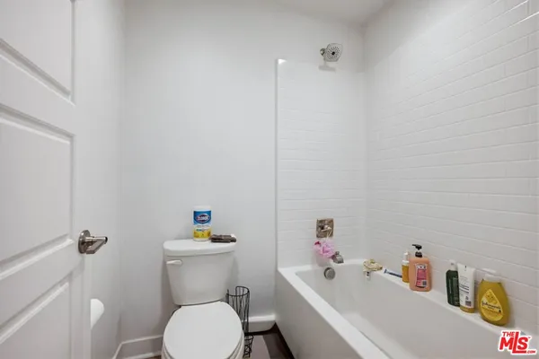 a view of a workspace with furniture and wooden floor