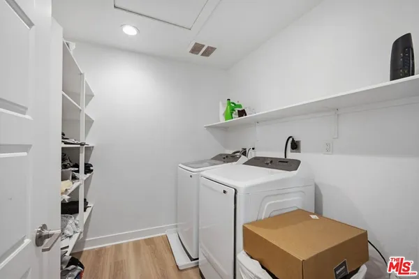 a living room with furniture a piano and a flat screen tv