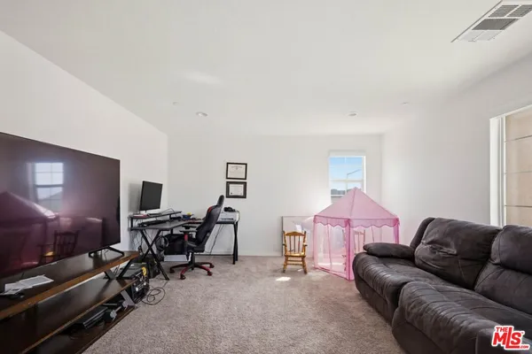 a spacious bedroom with a bed and a cabinets