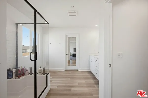 a spacious bathroom with a double vanity sink and a mirror