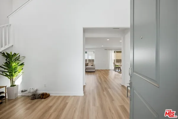 a view of a room with wooden floor and a potted plant