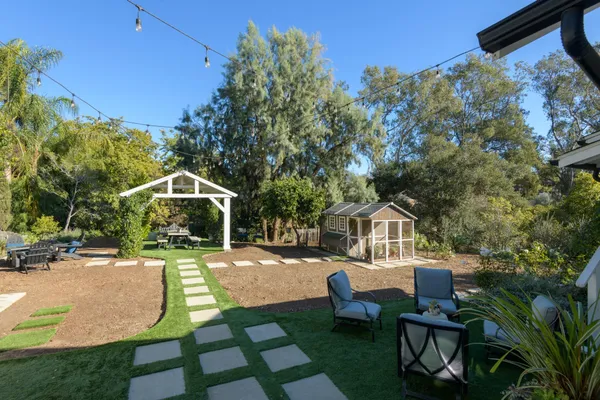 a swimming pool with outdoor seating and yard