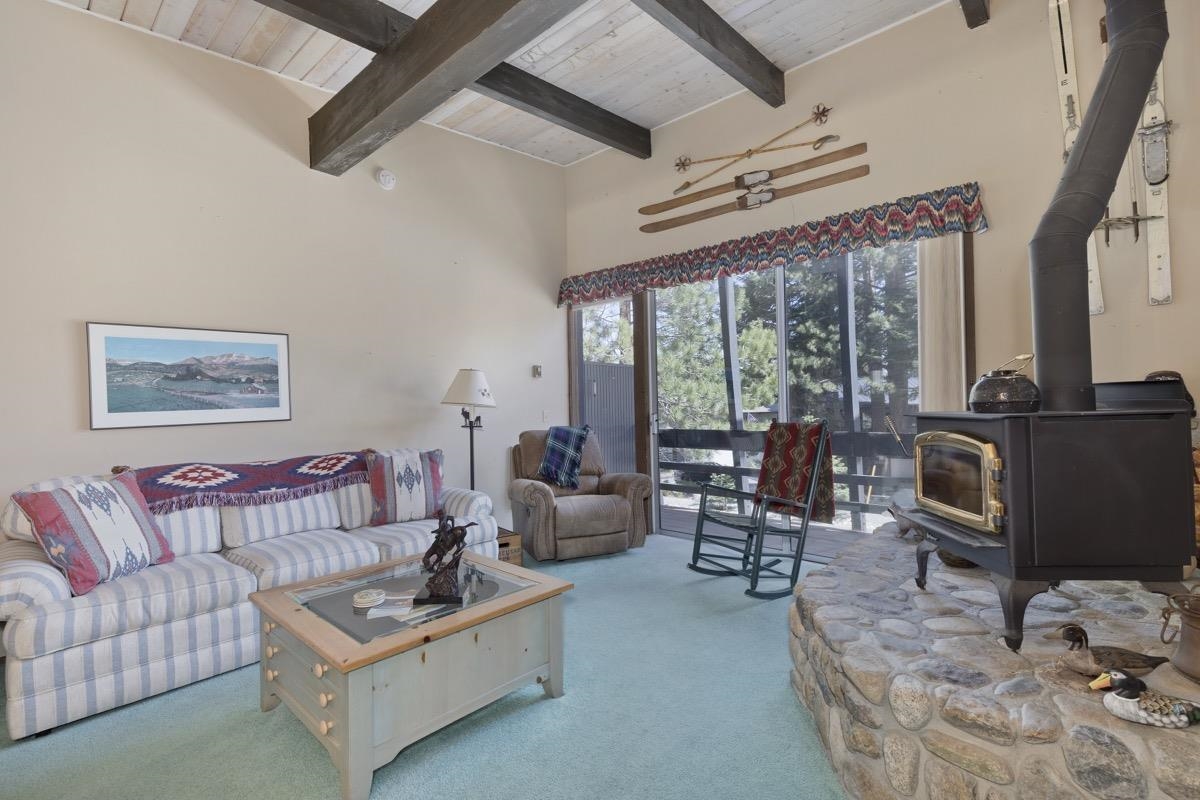 a living room with furniture a flat screen tv and a large window
