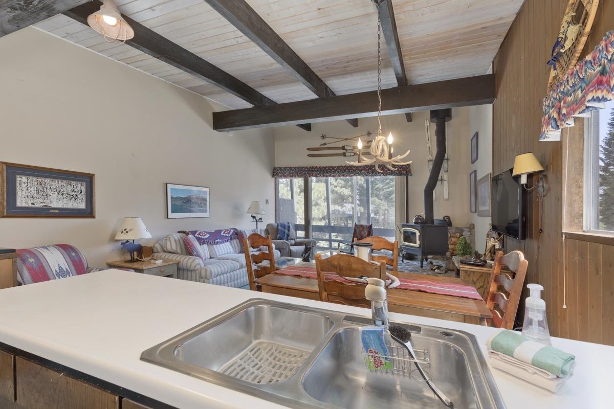 44 Tyrol Lane, Unit 209 Mammoth Lakes, CA 93546 - Photo 12 of 31 a living room with furniture a large window and a chandelier