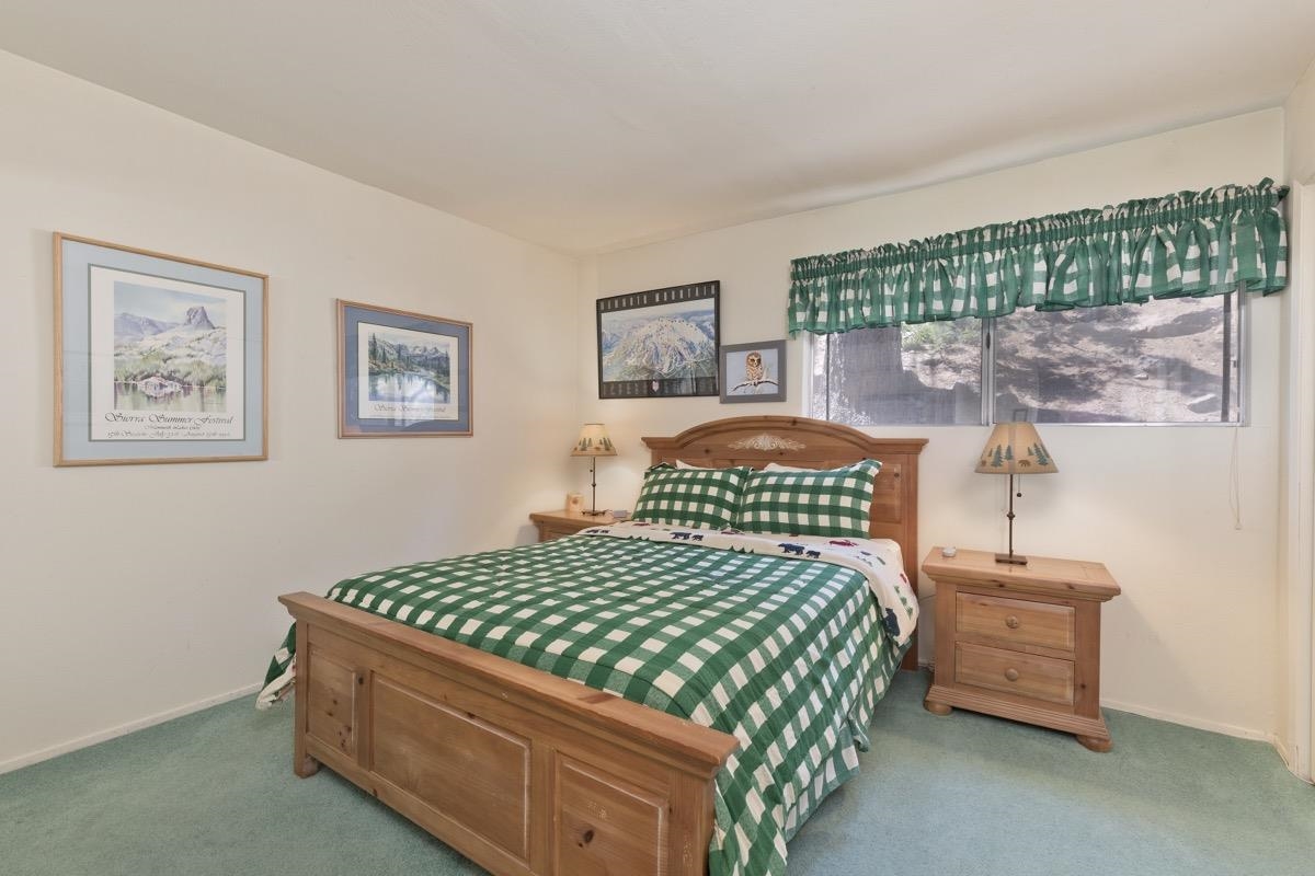 44 Tyrol Lane, Unit 209 Mammoth Lakes, CA 93546 - Photo 19 of 31 a bedroom with a bed and a painting on the wall