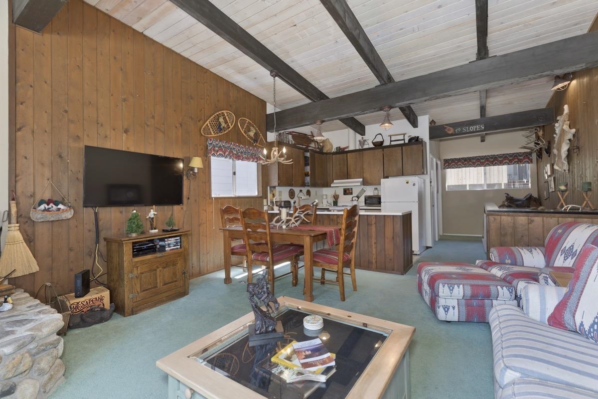 44 Tyrol Lane, Unit 209 Mammoth Lakes, CA 93546 - Photo 6 of 31 a living room with furniture and a flat screen tv